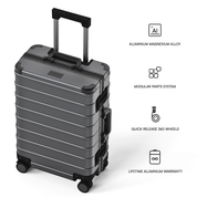 A dark gray hard-shell rolling suitcase shown on a white background with feature callouts and text describing aluminum magnesium alloy construction, modular parts system, quick release 360 wheels, and lifetime aluminum warranty.